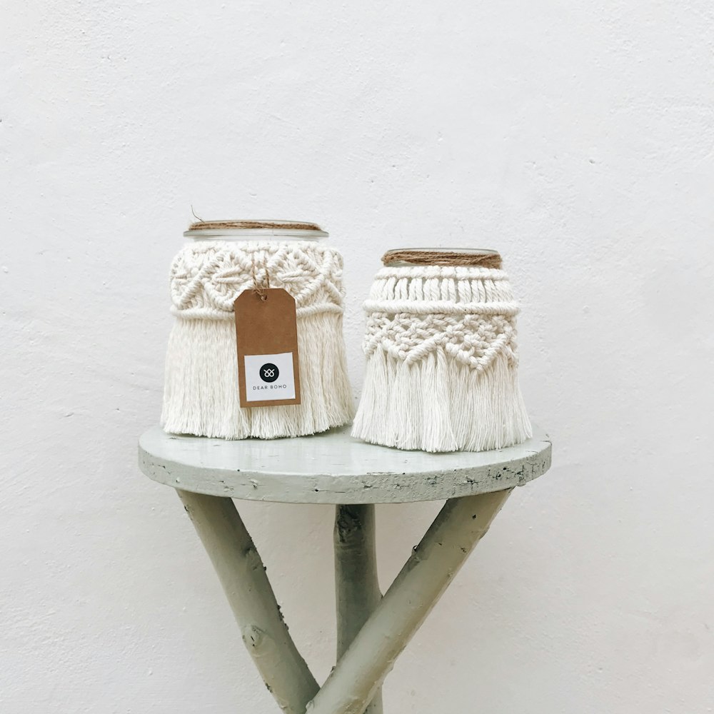 two white knitted baskets sitting on top of a table