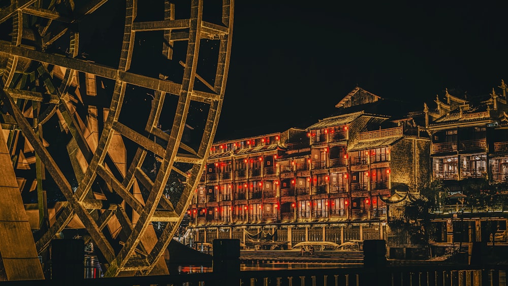 a very tall building with red lights on it's windows