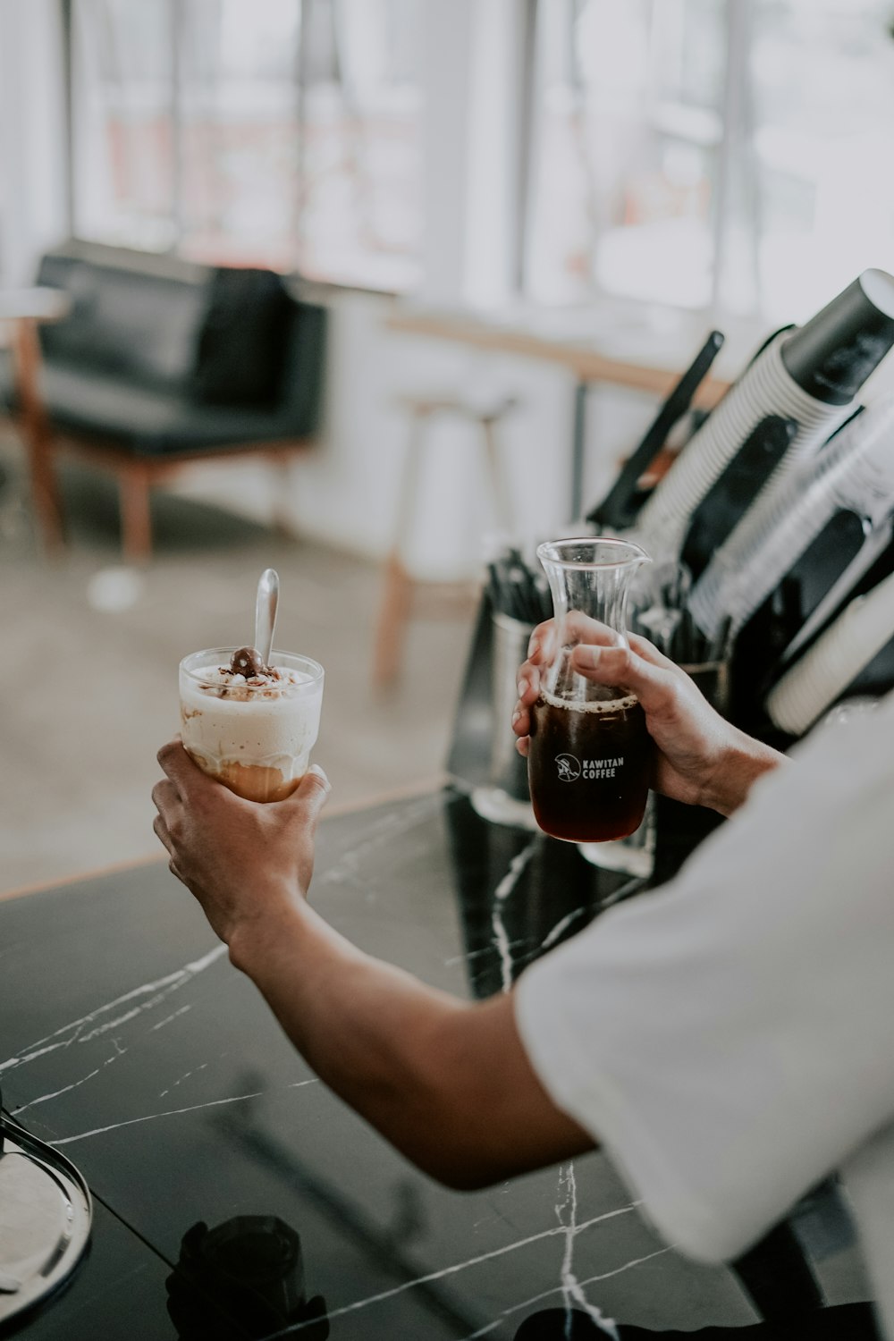 a man is holding a drink and a dessert