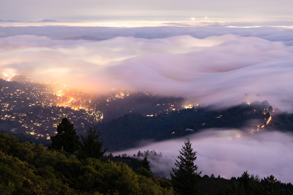 a view of the city lights in the clouds