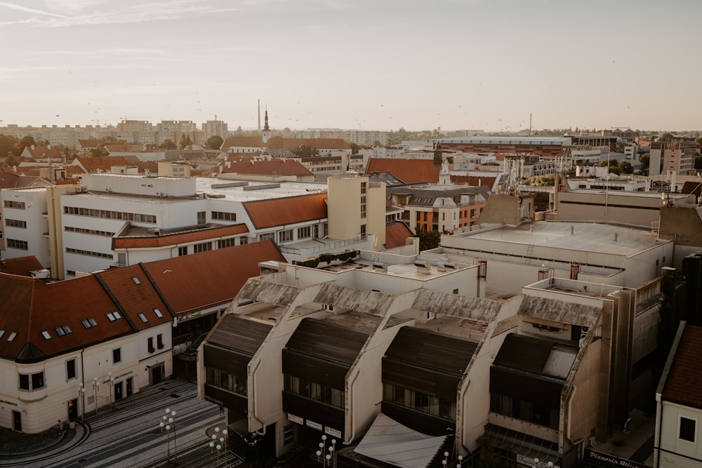 an aerial view of a city with buildings and train tracks