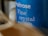 Close-up of a blue container labeled 'Waitrose Fine crystal sea salt,' with slightly blurred elements in the foreground creating a sense of depth.