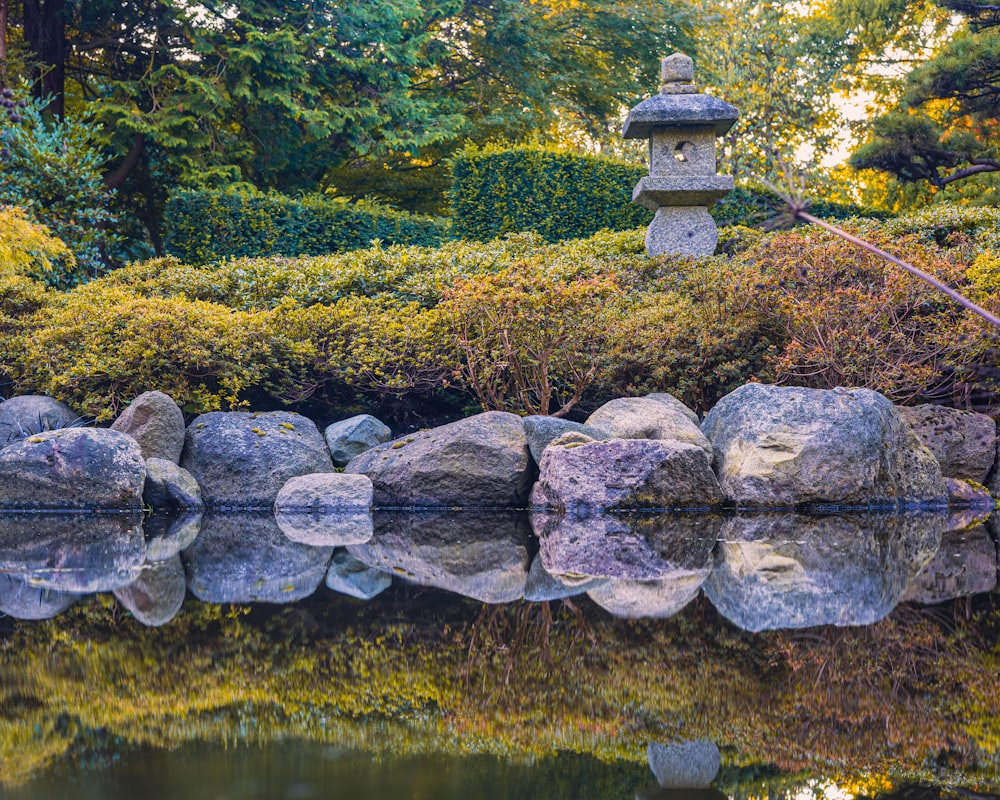 a pond with rocks in the middle of it