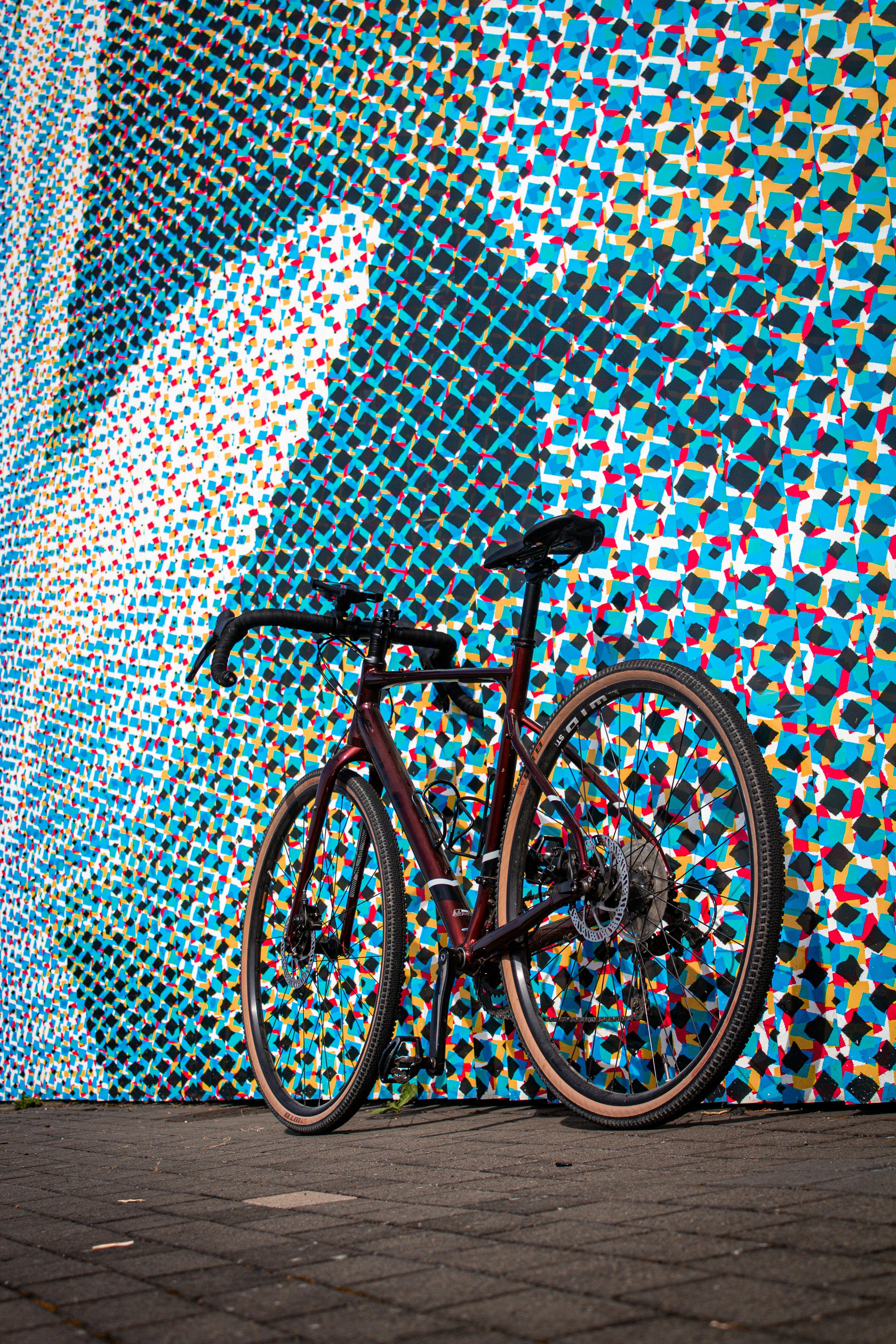 A bicycle parked in front of a colorful wall photo – Free Art Image on ...
