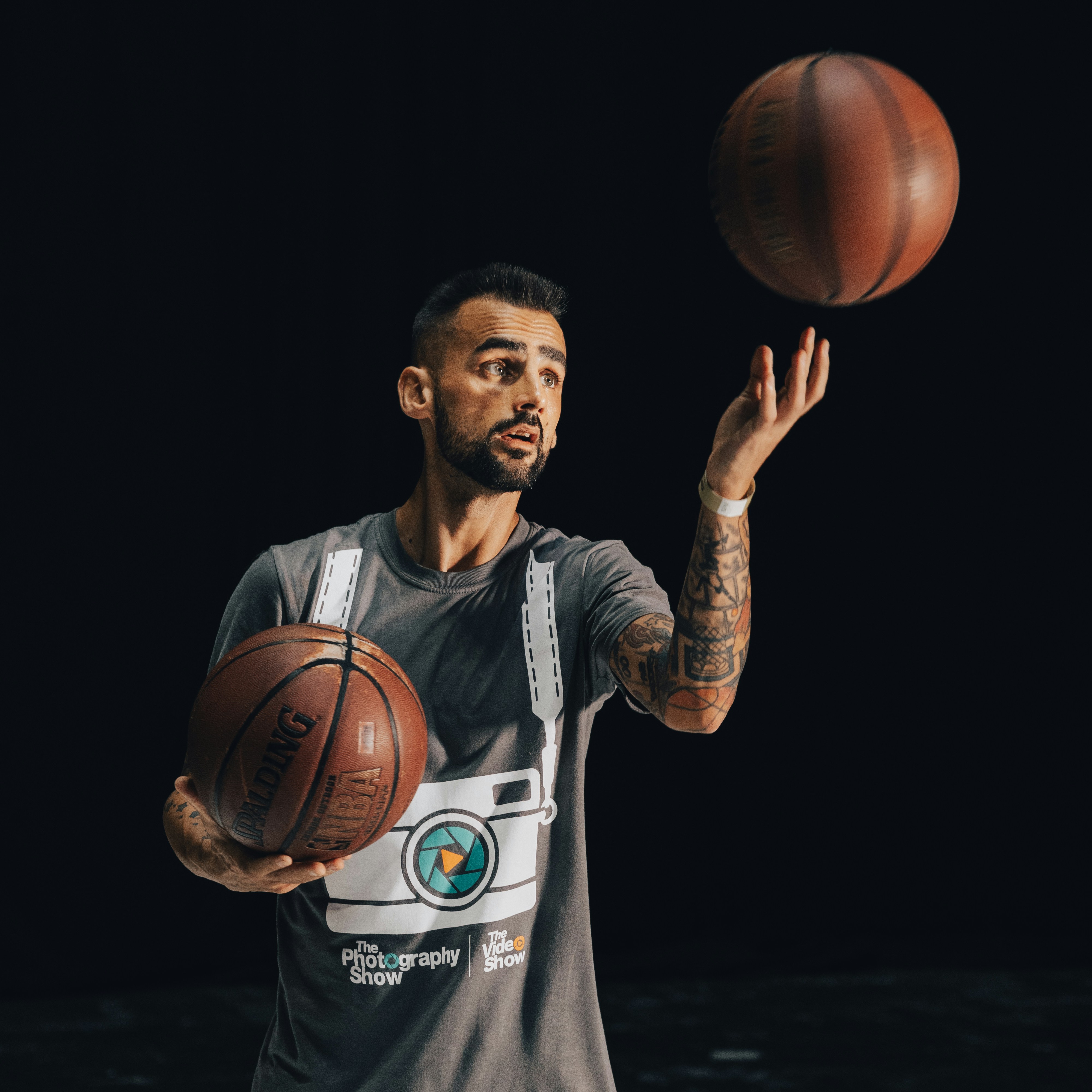 a man holding a basketball in one hand and a basketball in the other
