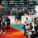 Innovative technology booth showcasing interactive gadgets under warm lighting.