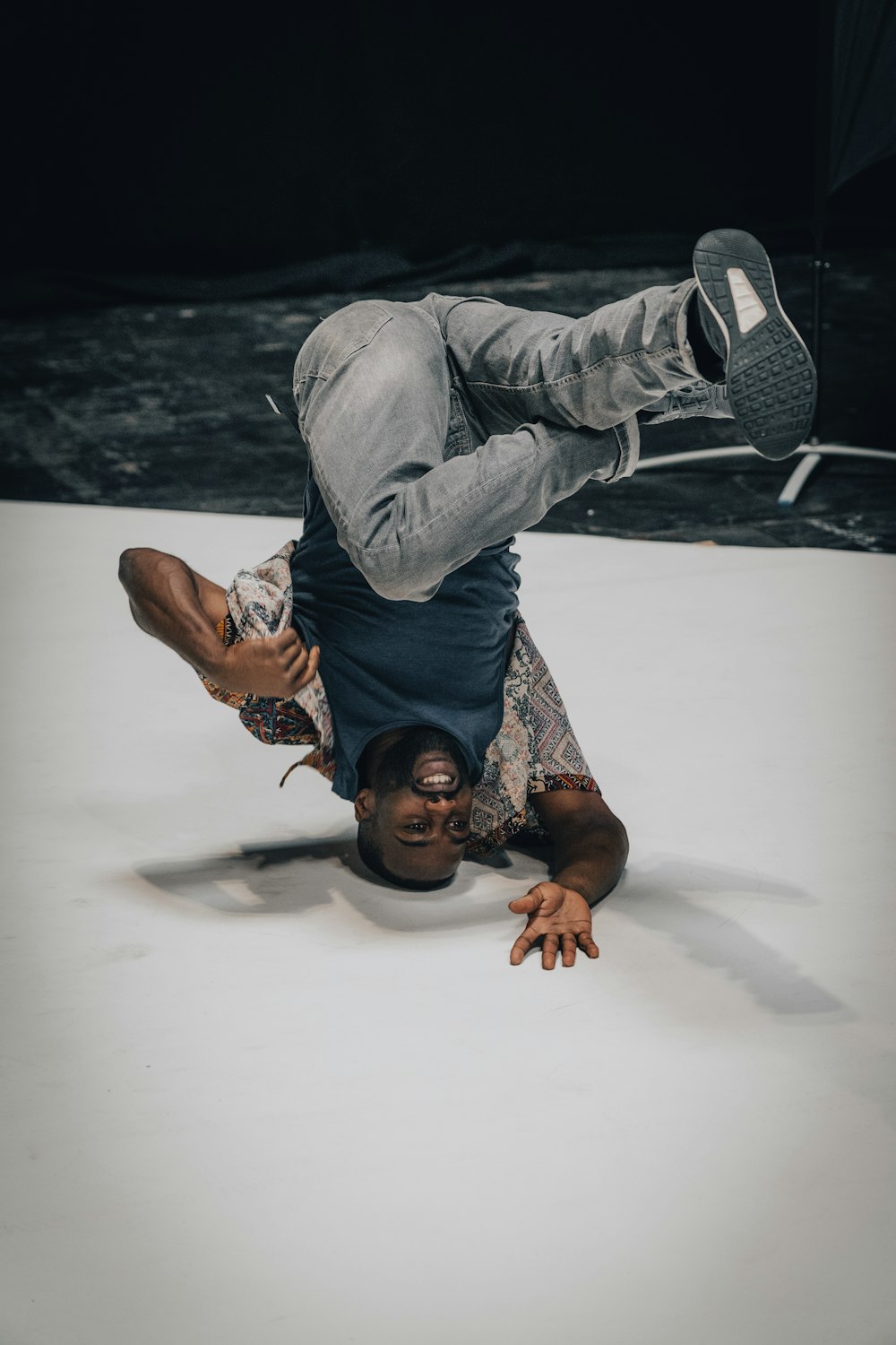 a man is doing a handstand on the floor