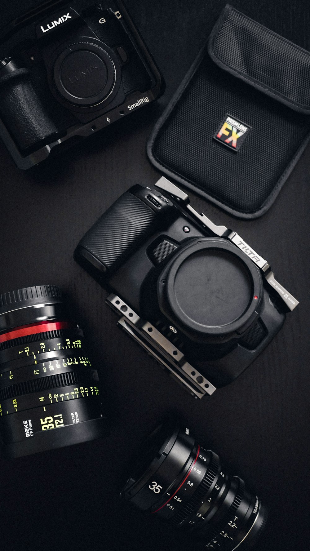 a camera, lens, and case sitting on a table