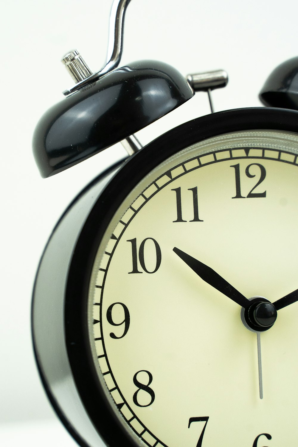 a black and white alarm clock on a white background