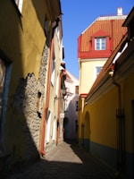 Historic cobblestone alley lined with charming old buildings under a clear blue sky