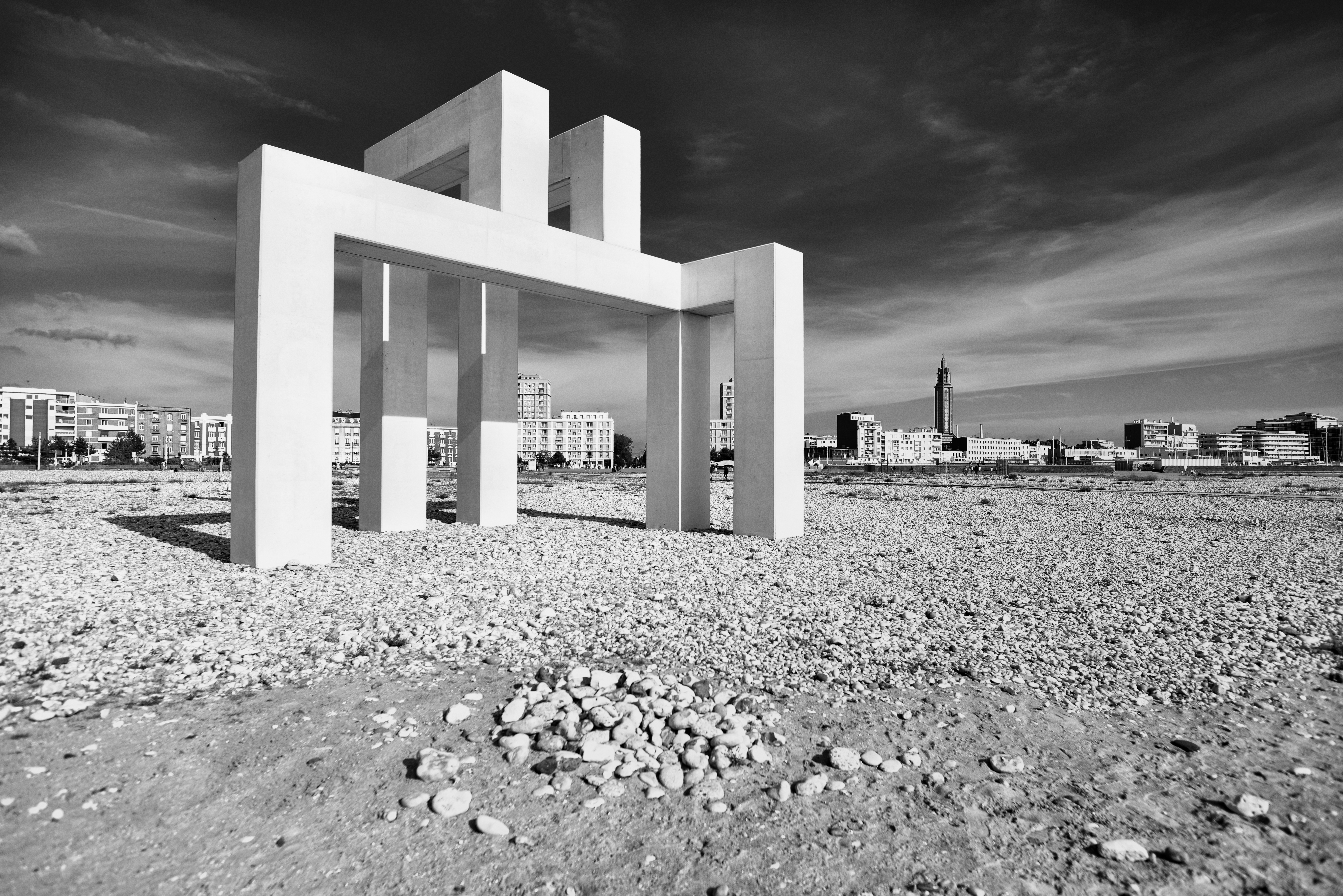 a black and white photo of a building in the desert