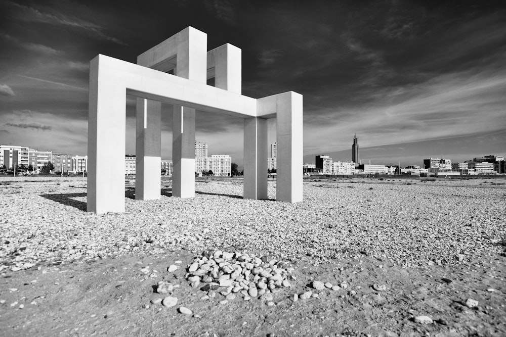 a black and white photo of a building in the desert