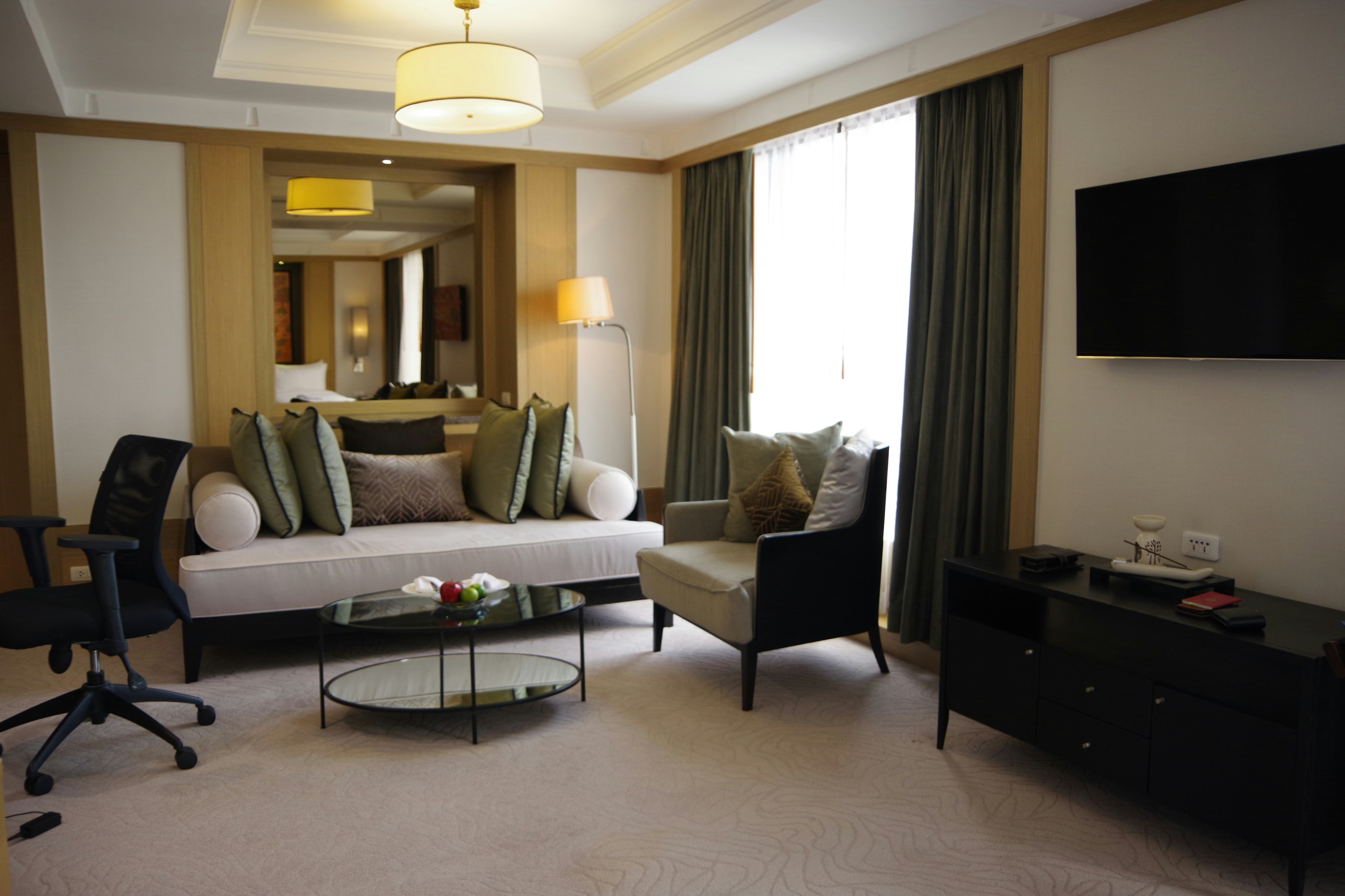 a living room filled with furniture and a flat screen tv
