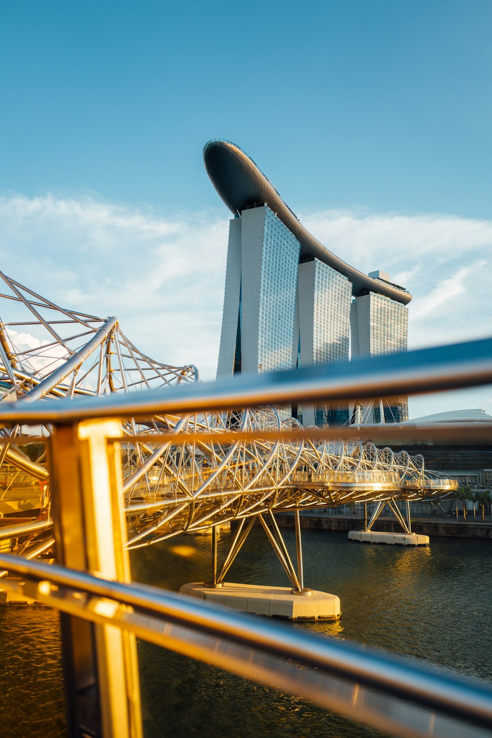 a bridge over a body of water with a building in the background