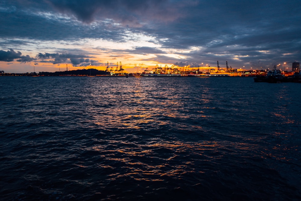 a large body of water with a city in the background