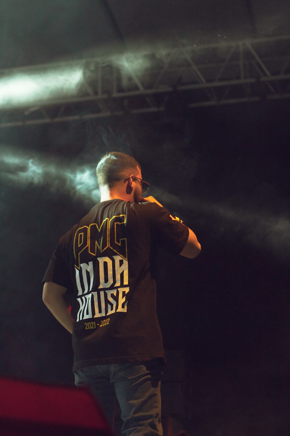 a man standing on top of a stage holding a microphone