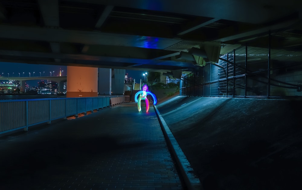 a person walking down a street at night