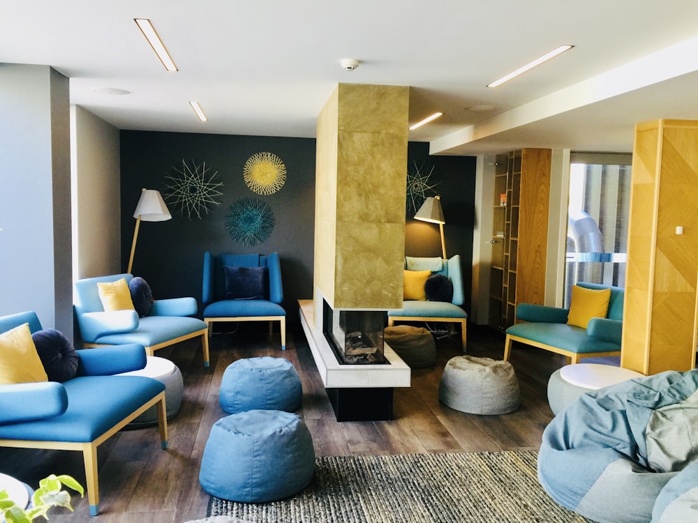 a living room filled with blue and yellow furniture