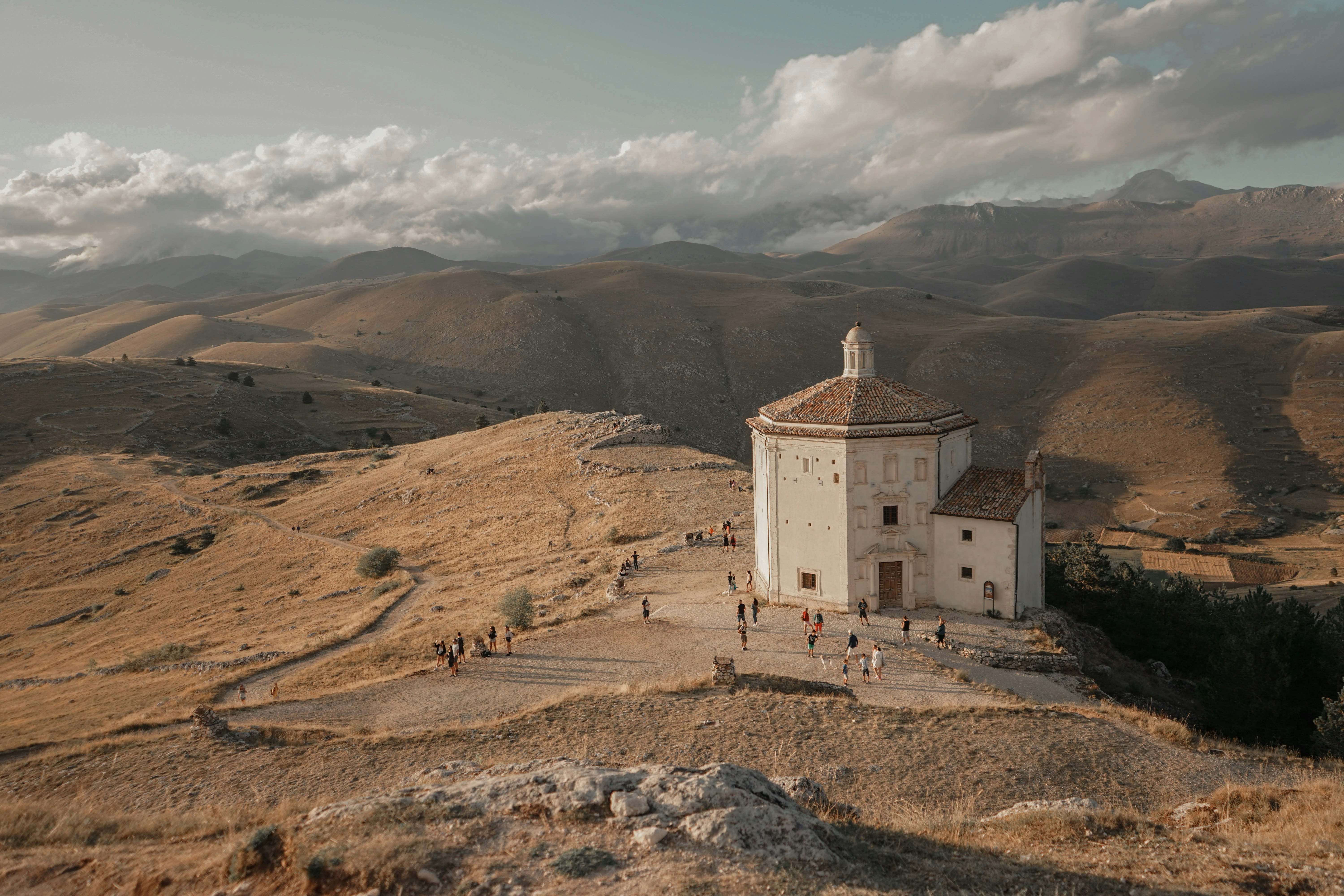 woman wearing yellow long-sleeved dress under white clouds and blue sky during daytime