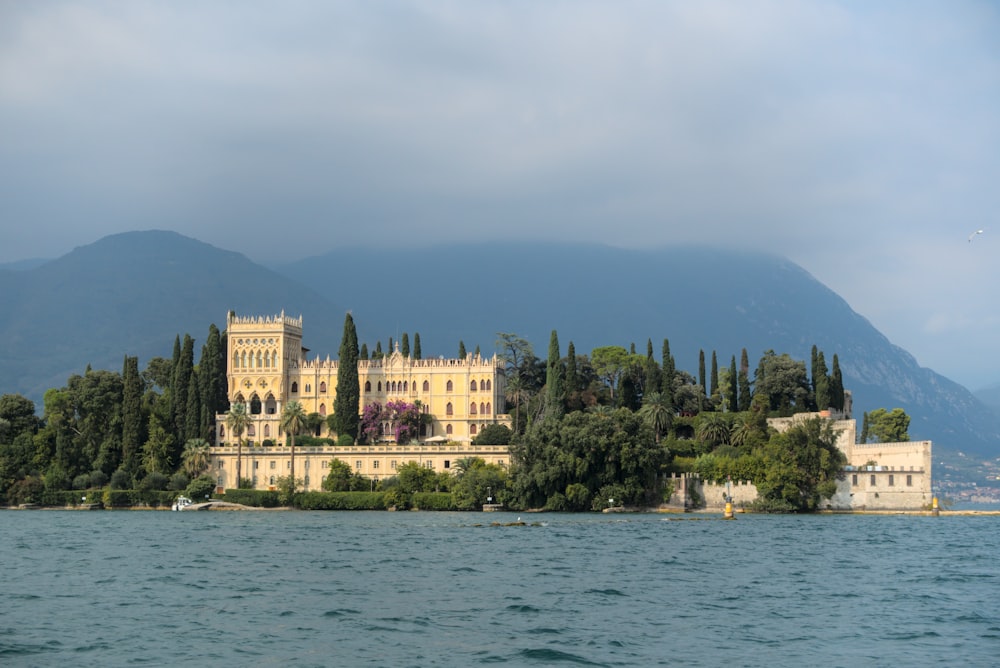 a large castle sitting on top of a lush green hillside