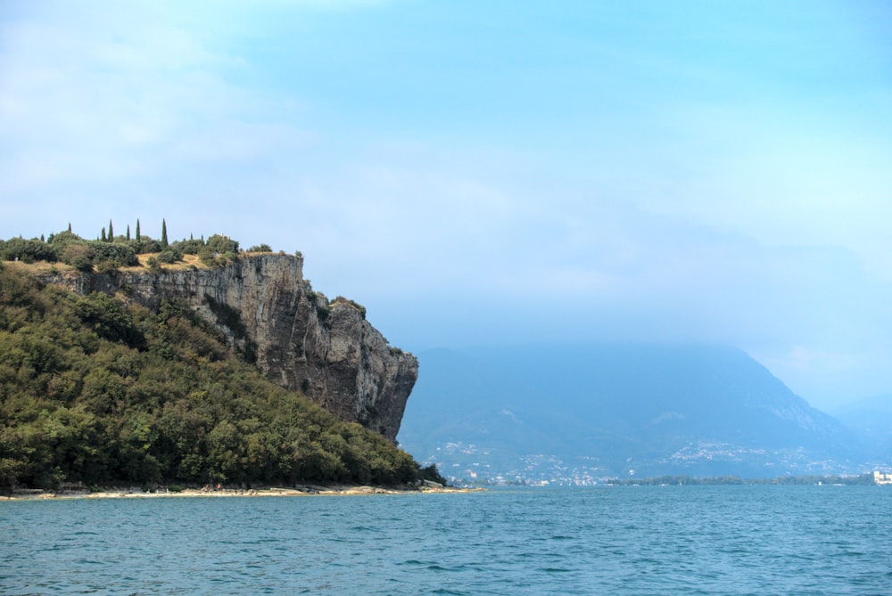 a large body of water with a mountain in the background