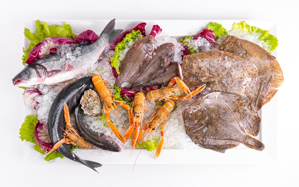 a white plate topped with different types of seafood