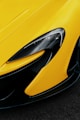 the front end of a yellow sports car
