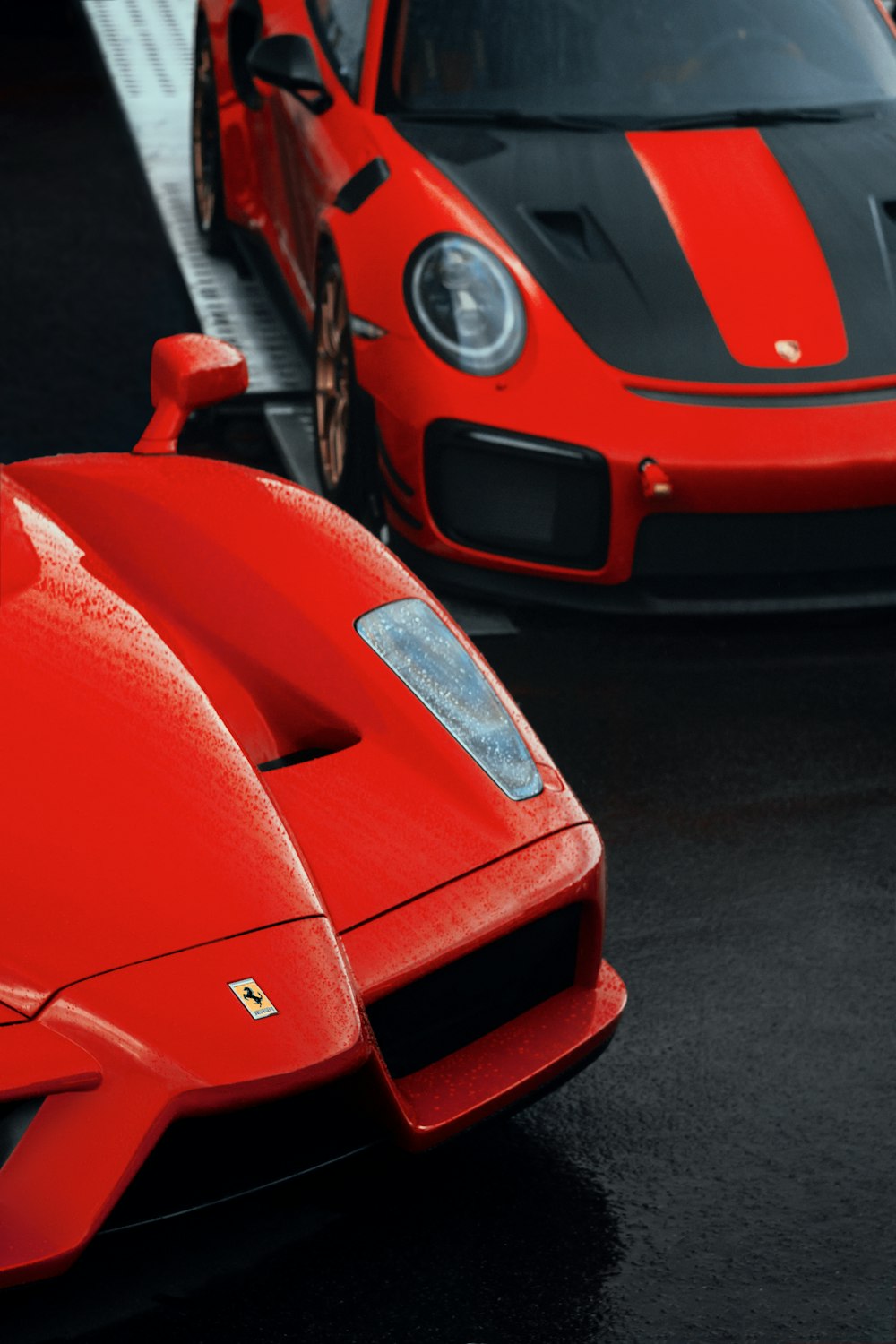 two red sports cars parked next to each other