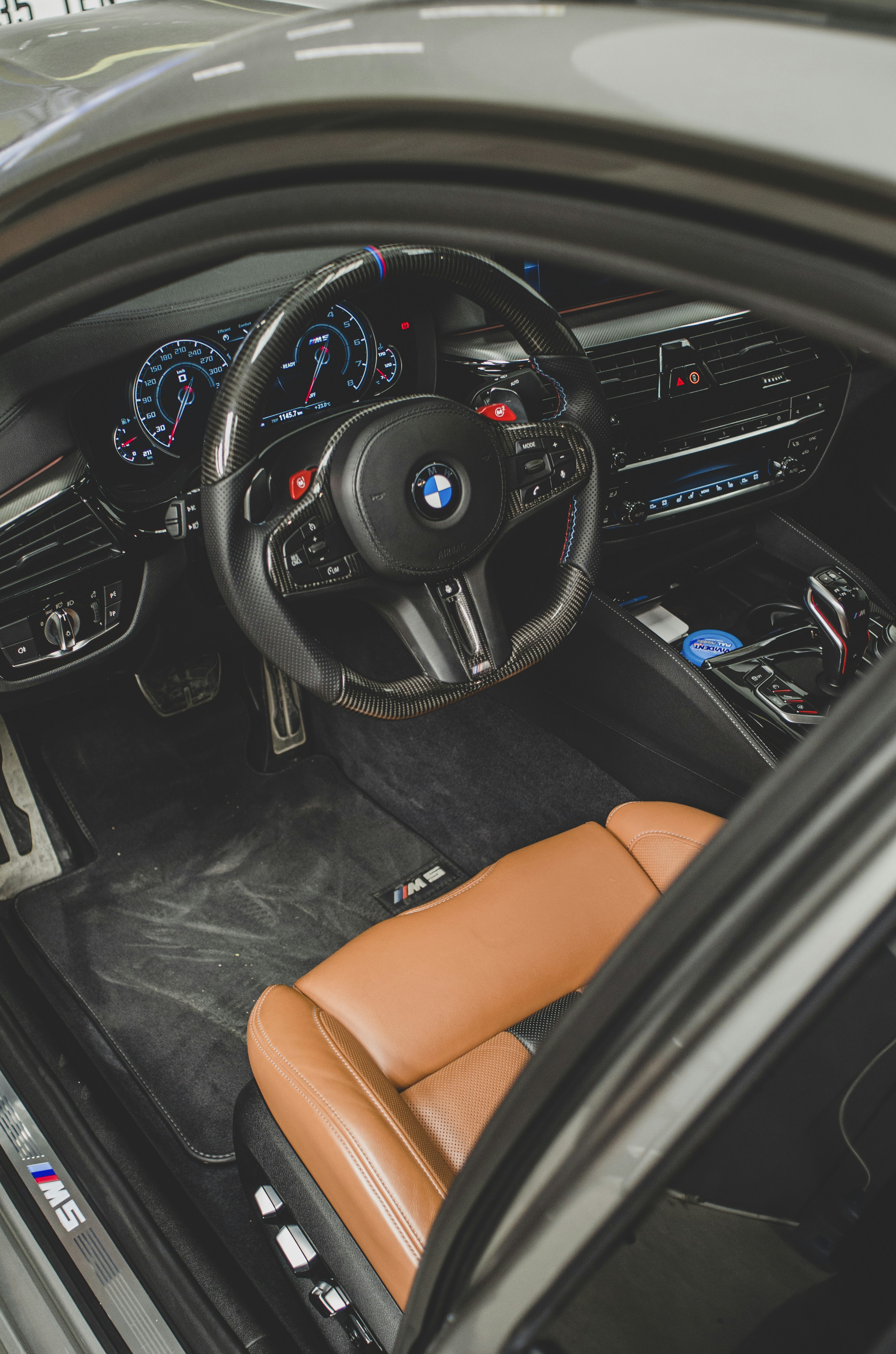 the interior of a car with a brown leather seat