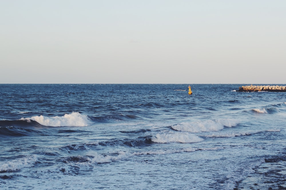 a body of water with waves coming in to shore