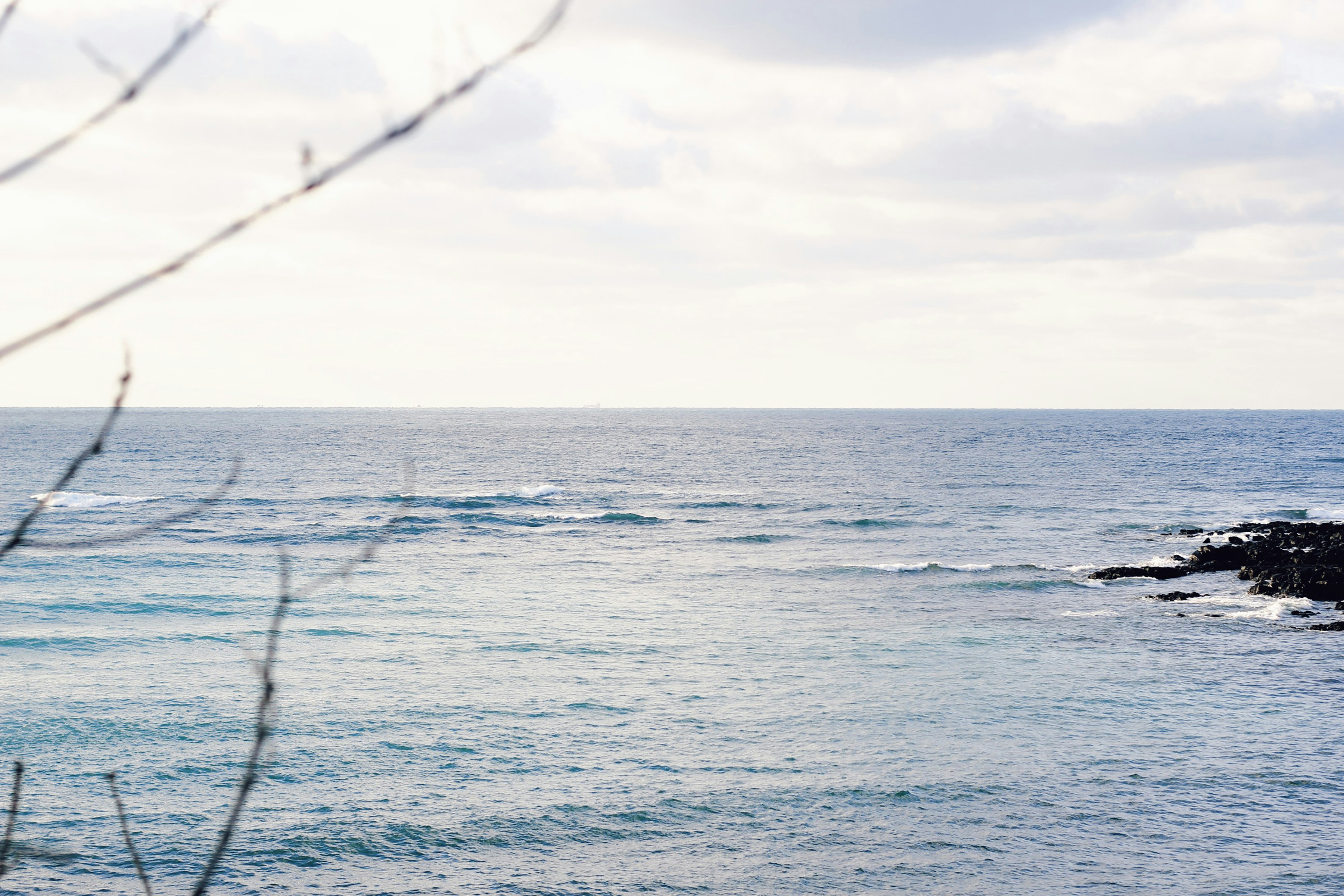 a body of water with waves coming in to shore