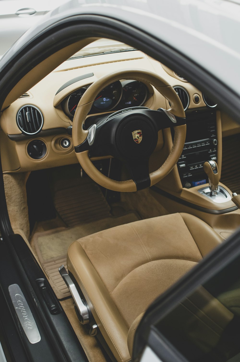 the interior of a car with a steering wheel and dashboard