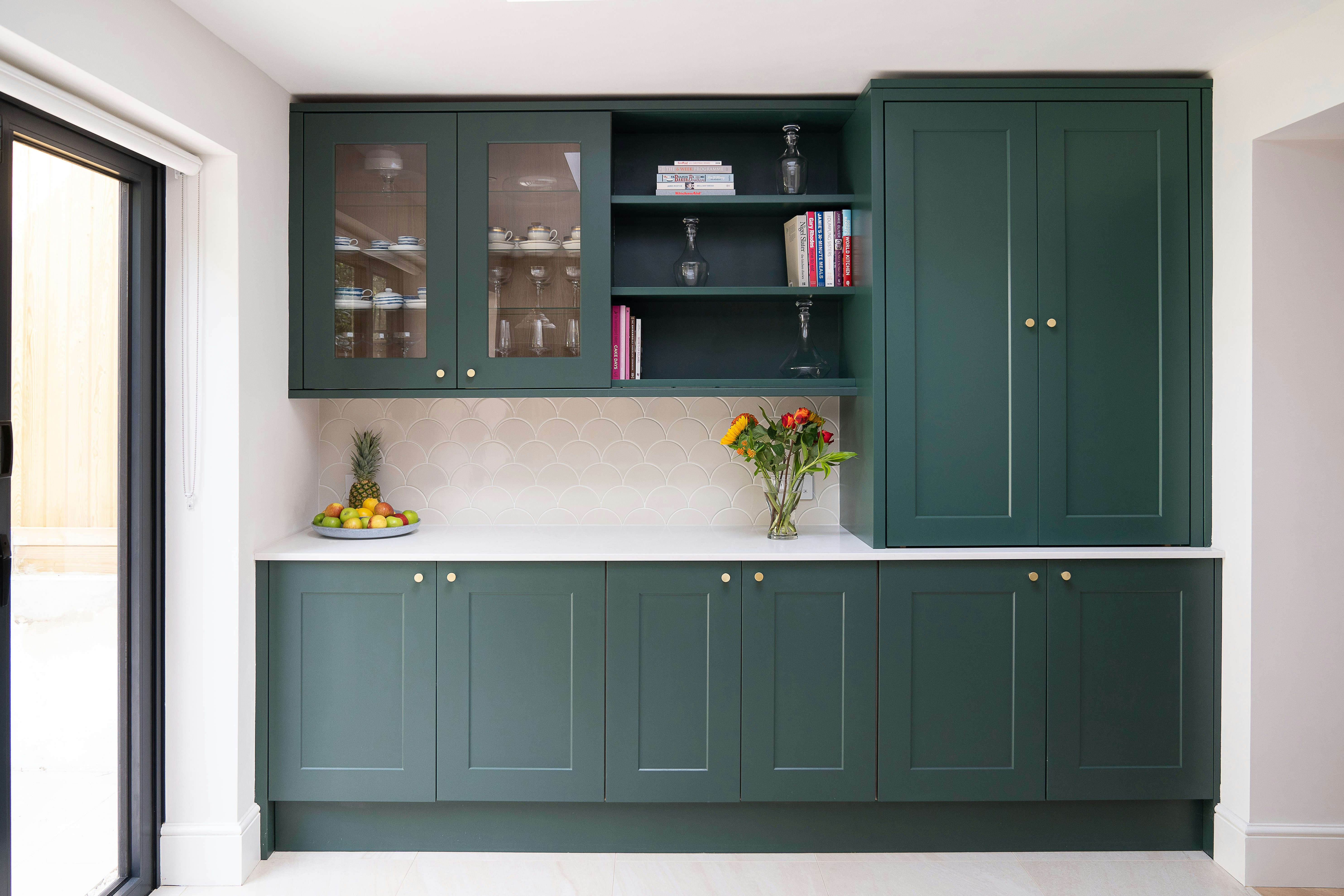 green kitchen cabinets Photo by Laurence Katz / Unsplash