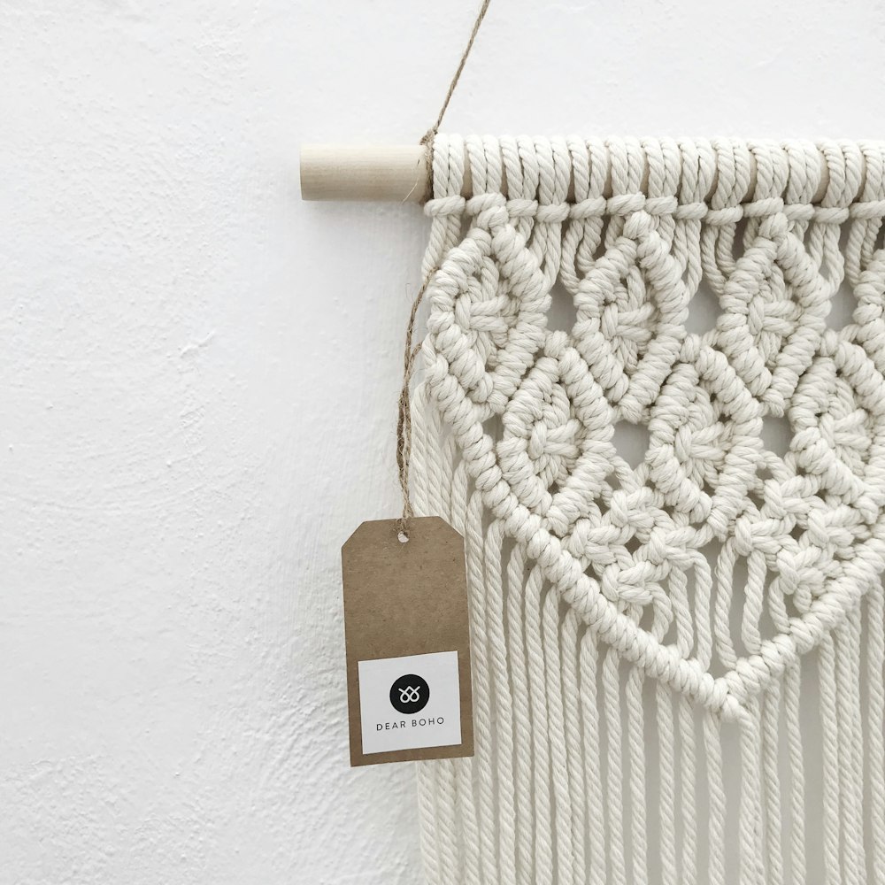 a white macrame hanging on a wall