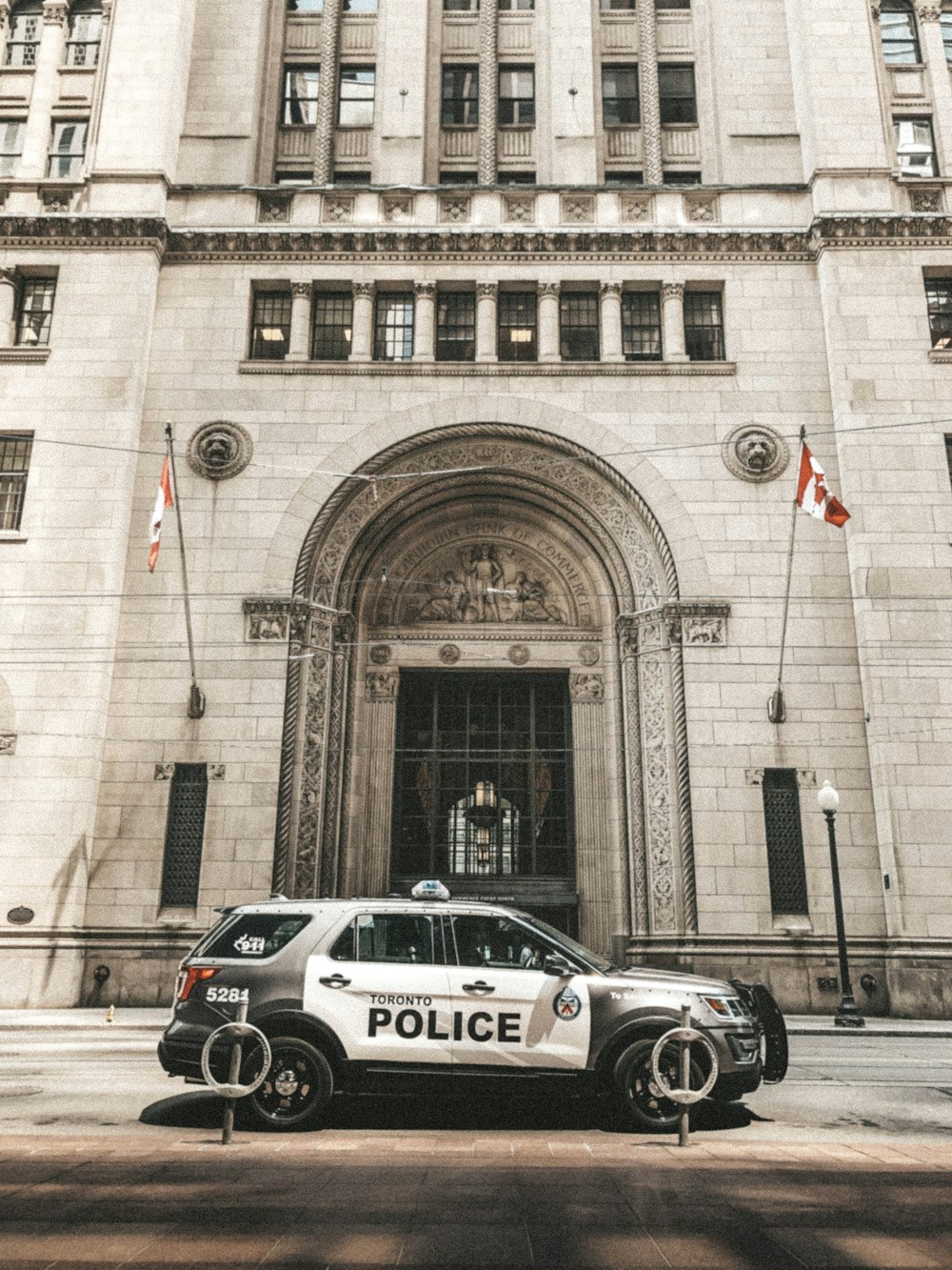 a police car parked in front of a large building