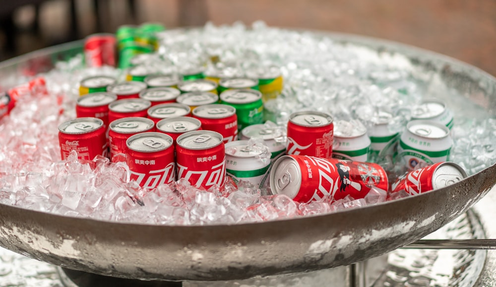 a metal tray filled with lots of soda cans
