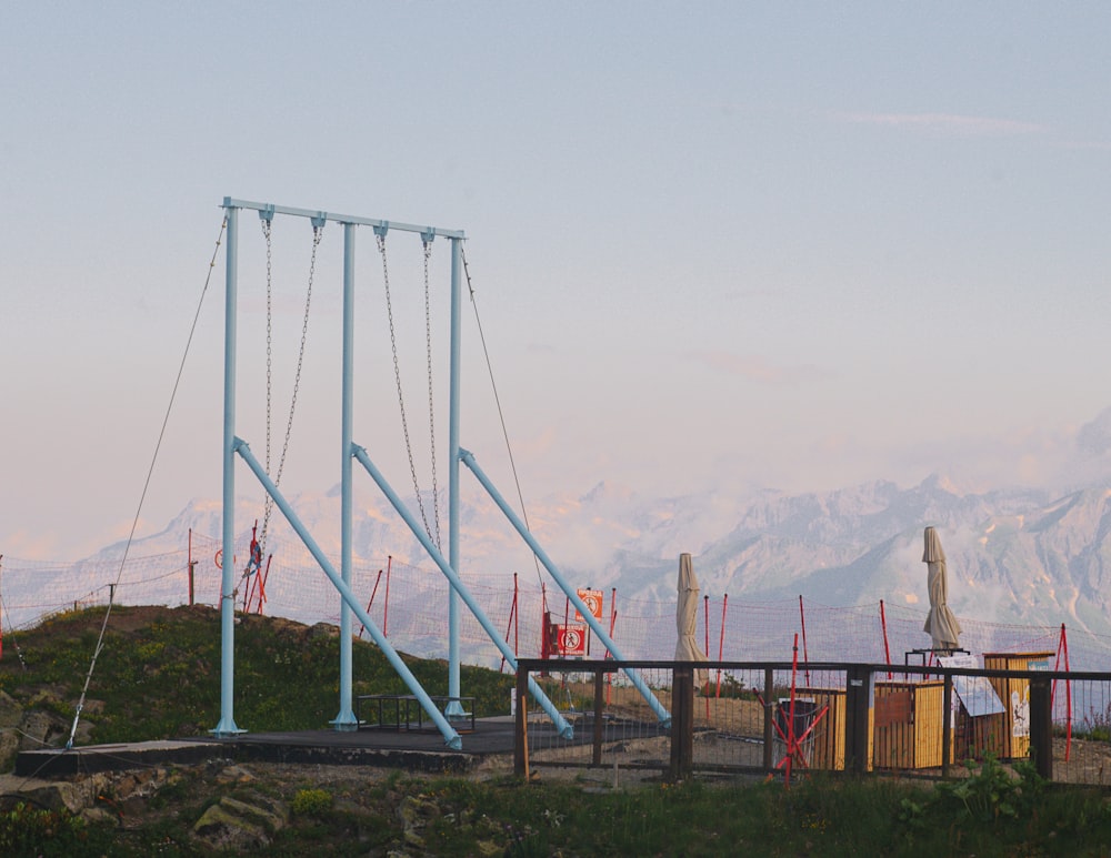 a roller coaster with mountains in the background