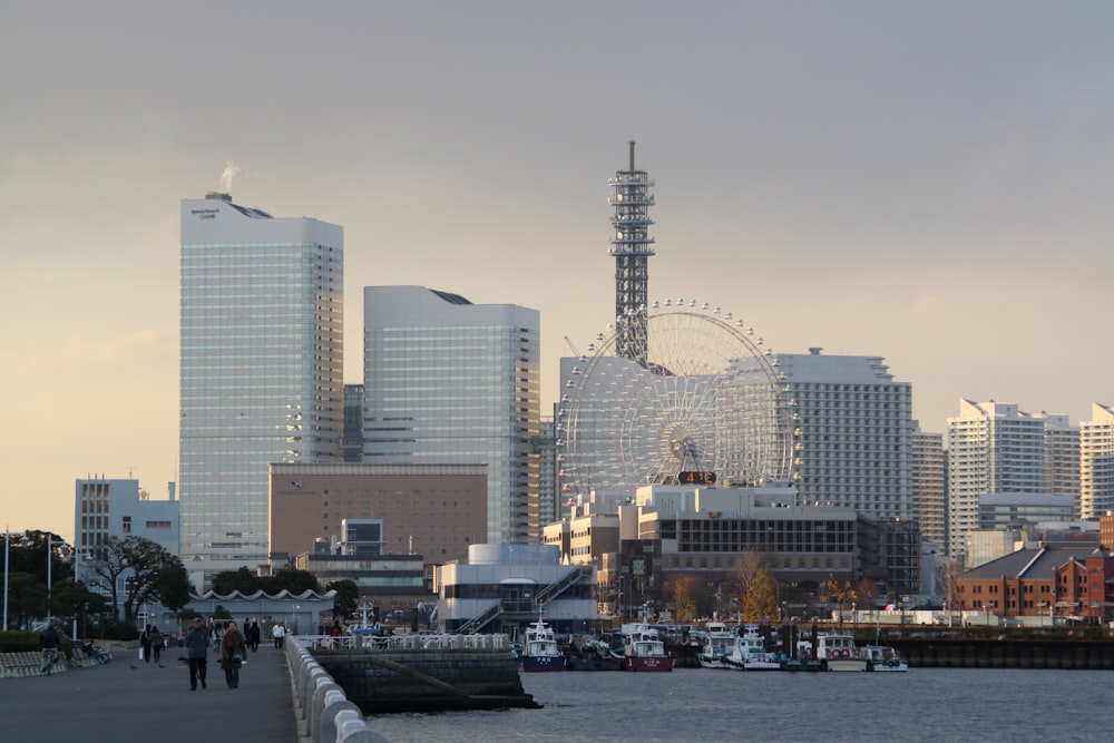 a city skyline with a ferris wheel in the distance