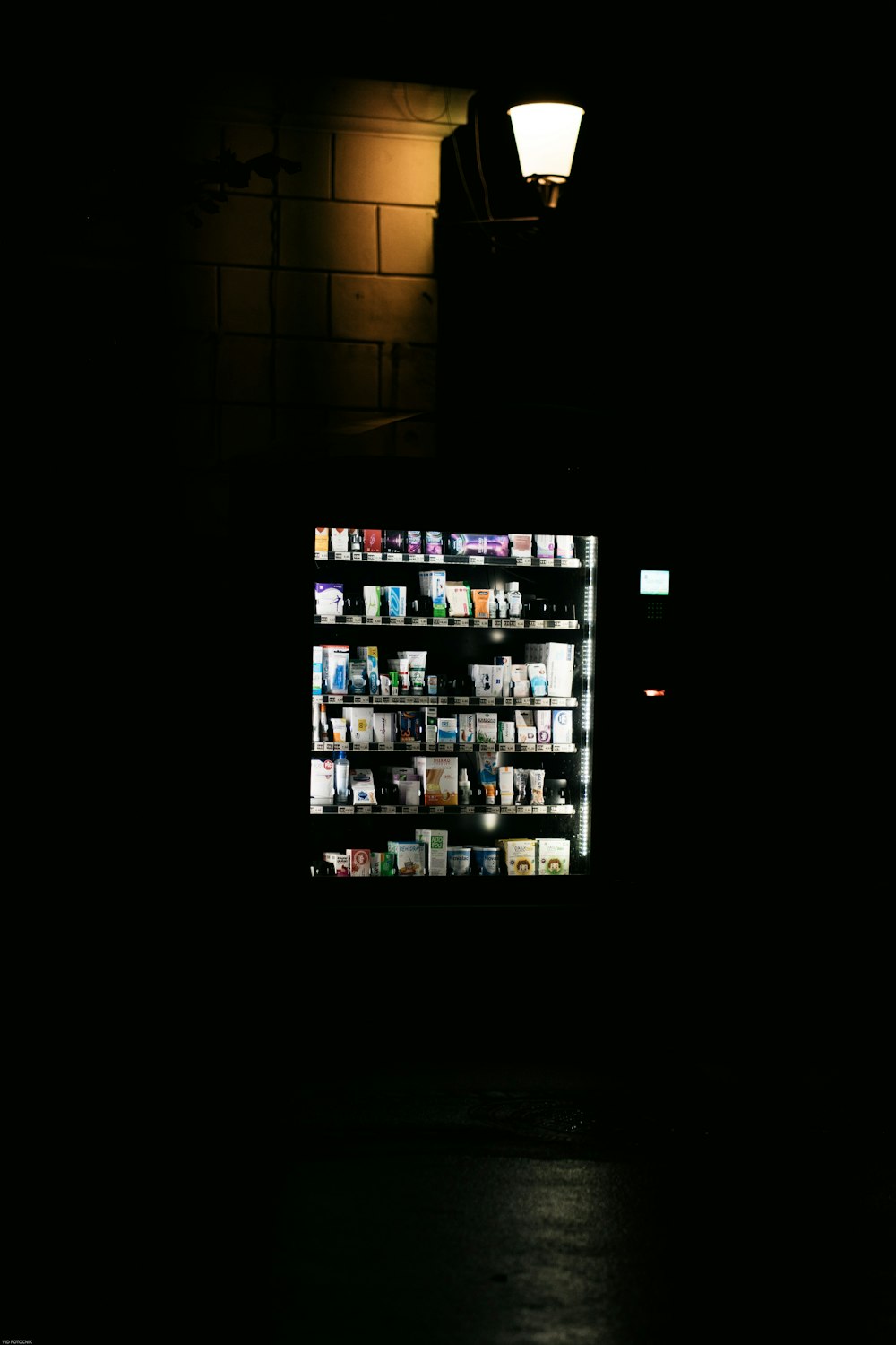 a dark room with a lighted book shelf