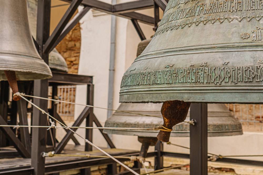 a large metal bell sitting on top of a wooden table