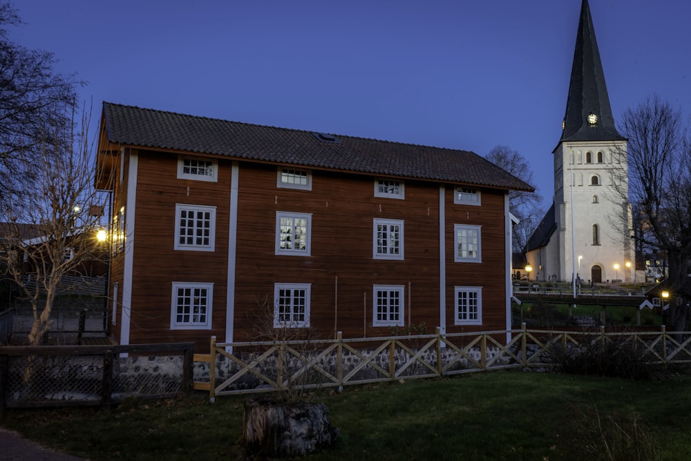 a wooden building with a steeple and a clock tower