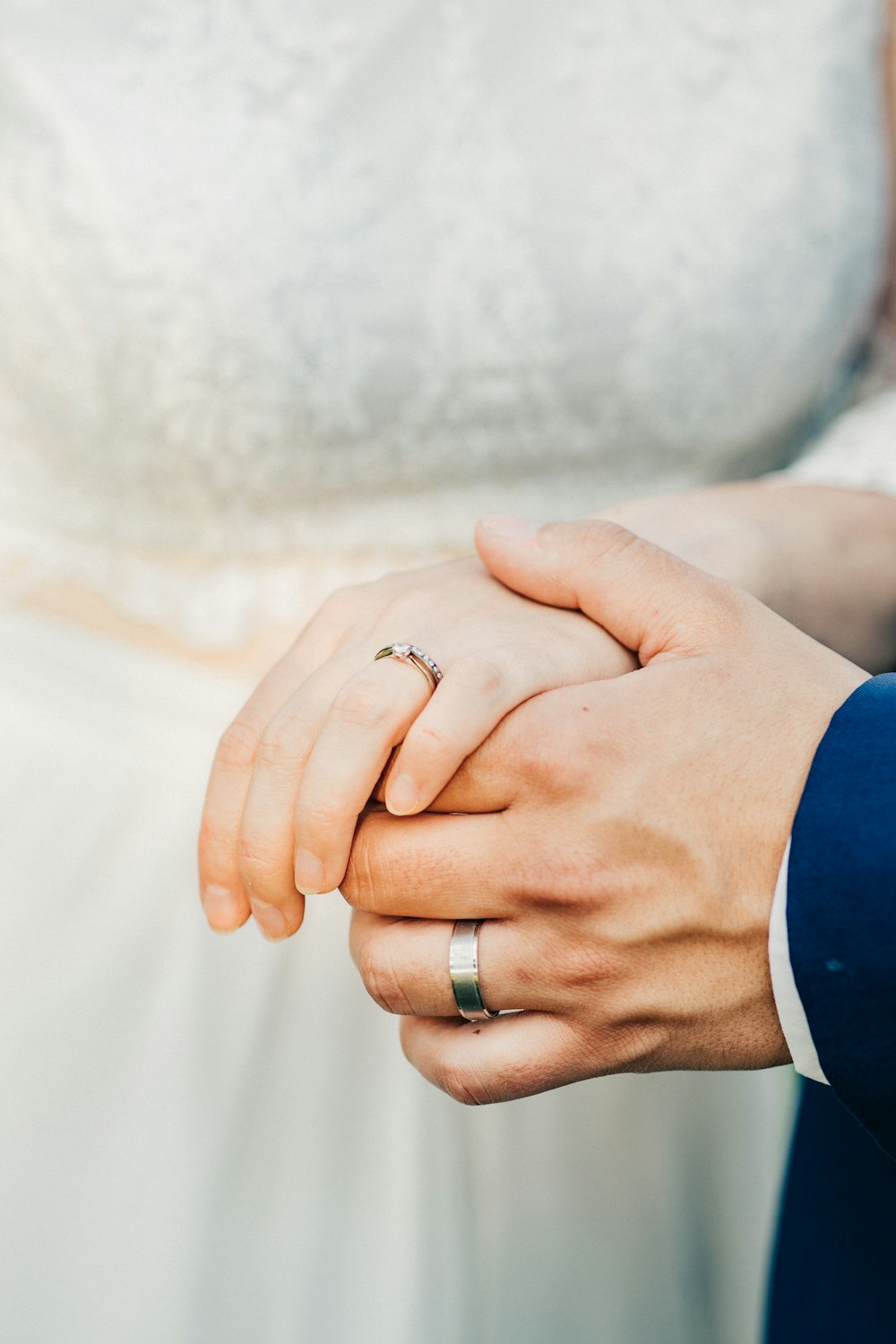 a close up of two people holding hands