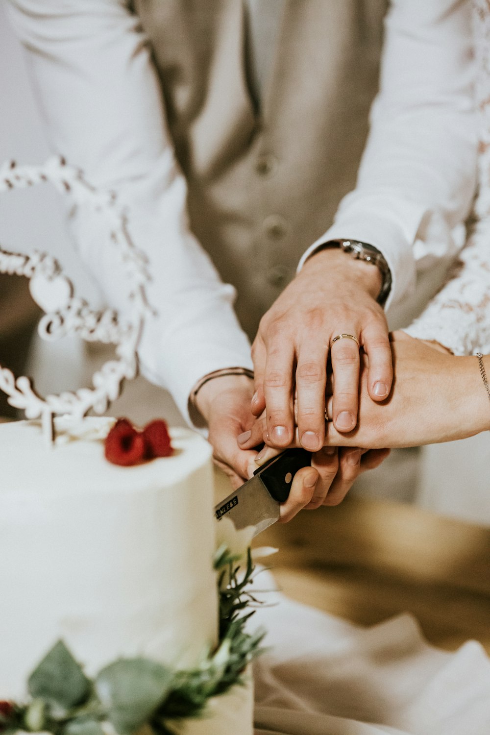 a bride and groom cutting their wedding cake