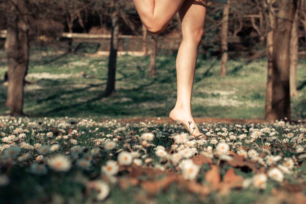 a person is running through a field of flowers