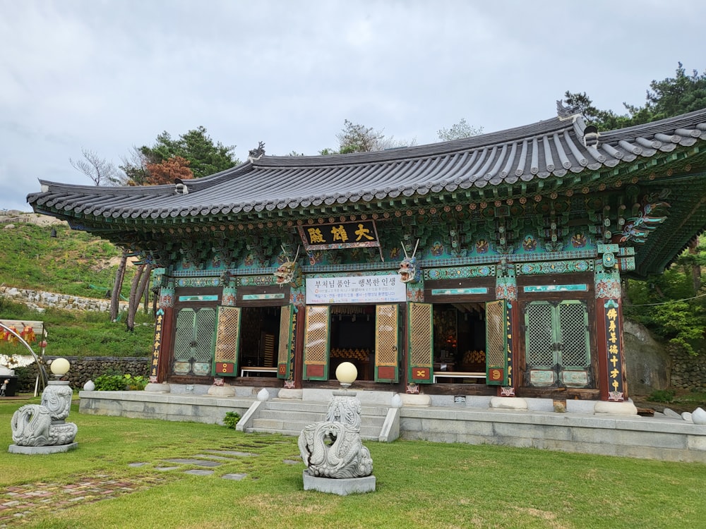 a chinese building with statues in front of it