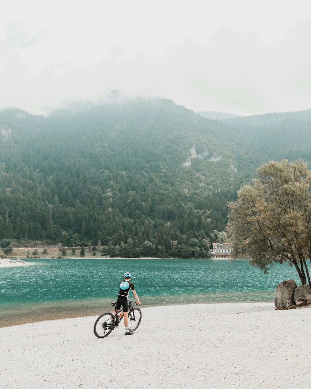 a person riding a bike on a beach