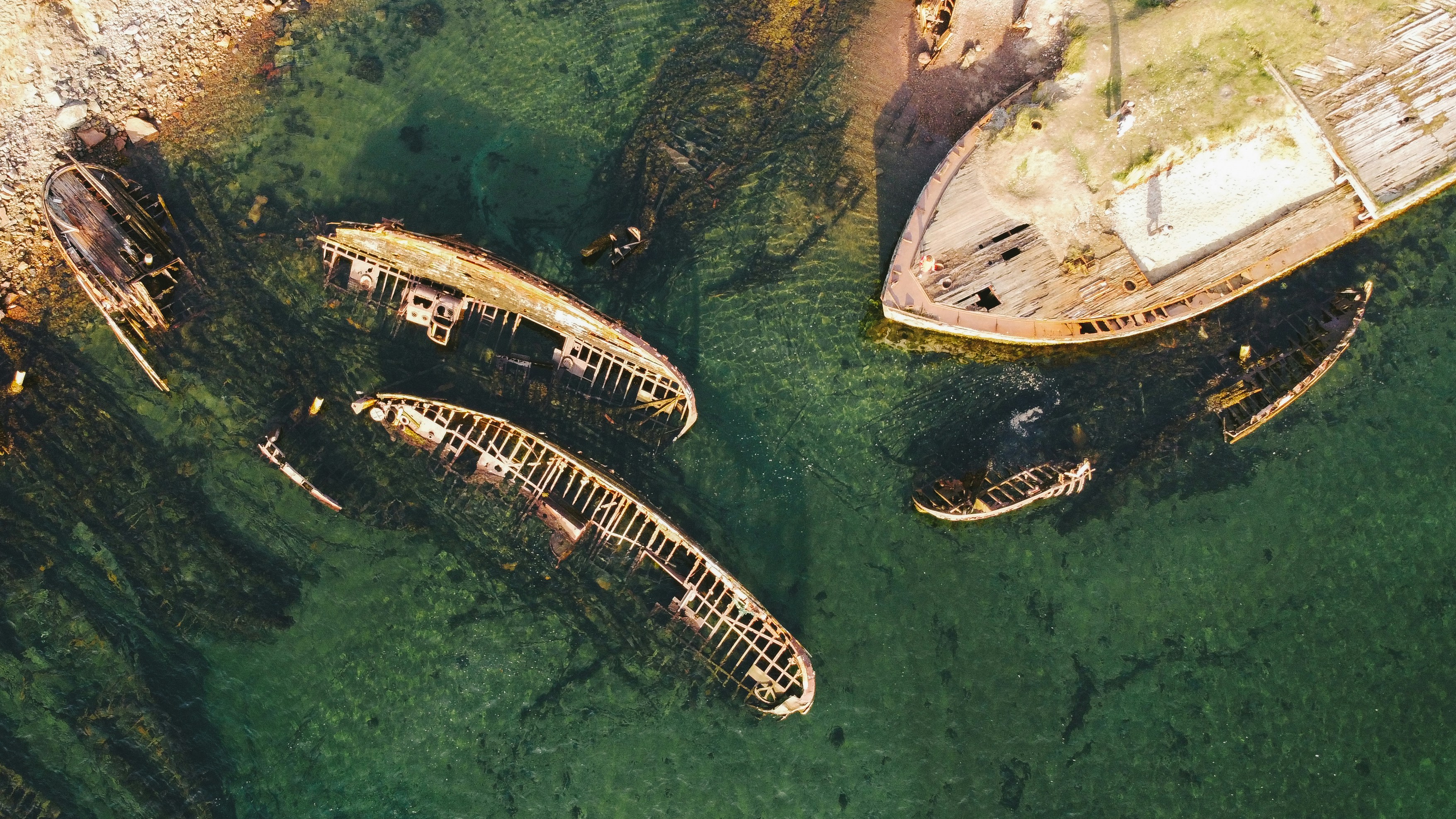 a group of boats sitting on top of a body of water