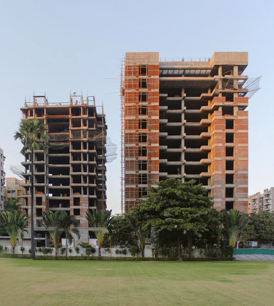 Two tall buildings side by side, one still under construction, Surat, India