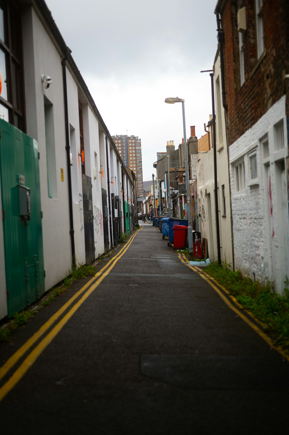 a narrow city street with buildings on both sides