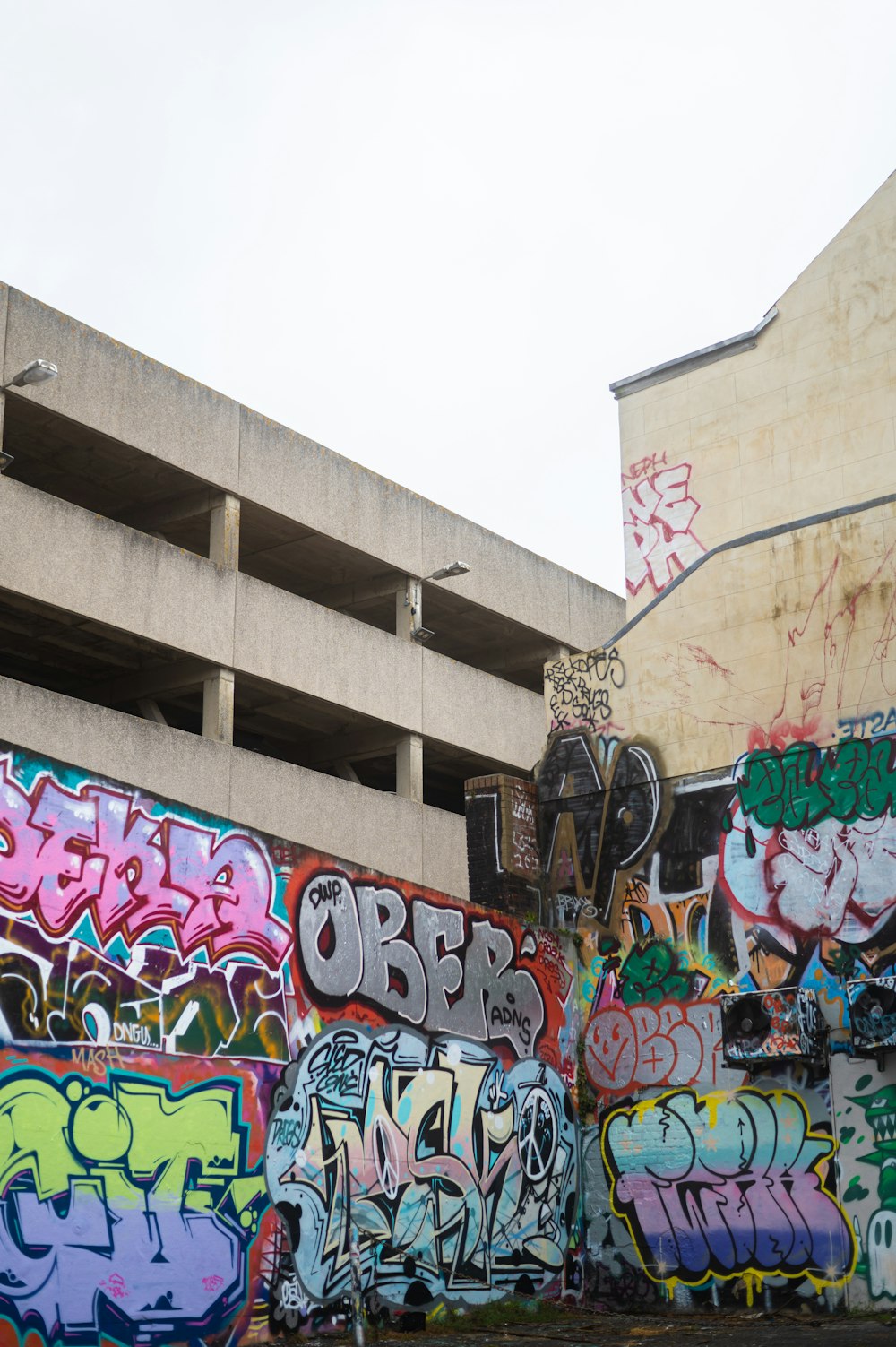 a bunch of graffiti on the side of a building